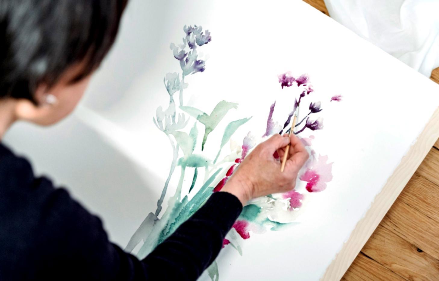 Artist's workspace showing various drawing materials and figure studies